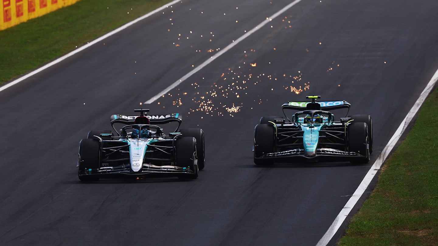 MONZA, ITALY - SEPTEMBER 01: George Russell of Great Britain driving the (63) Mercedes AMG Petronas F1 Team W15 battle for track position with Fernando Alonso of Spain driving the (14) Aston Martin AMR24 Mercedes during the F1 Grand Prix of Italy at Autodromo Nazionale Monza on September 01, 2024 in Monza, Italy. (Photo by Joe Portlock - Formula 1/Formula 1 via Getty Images)