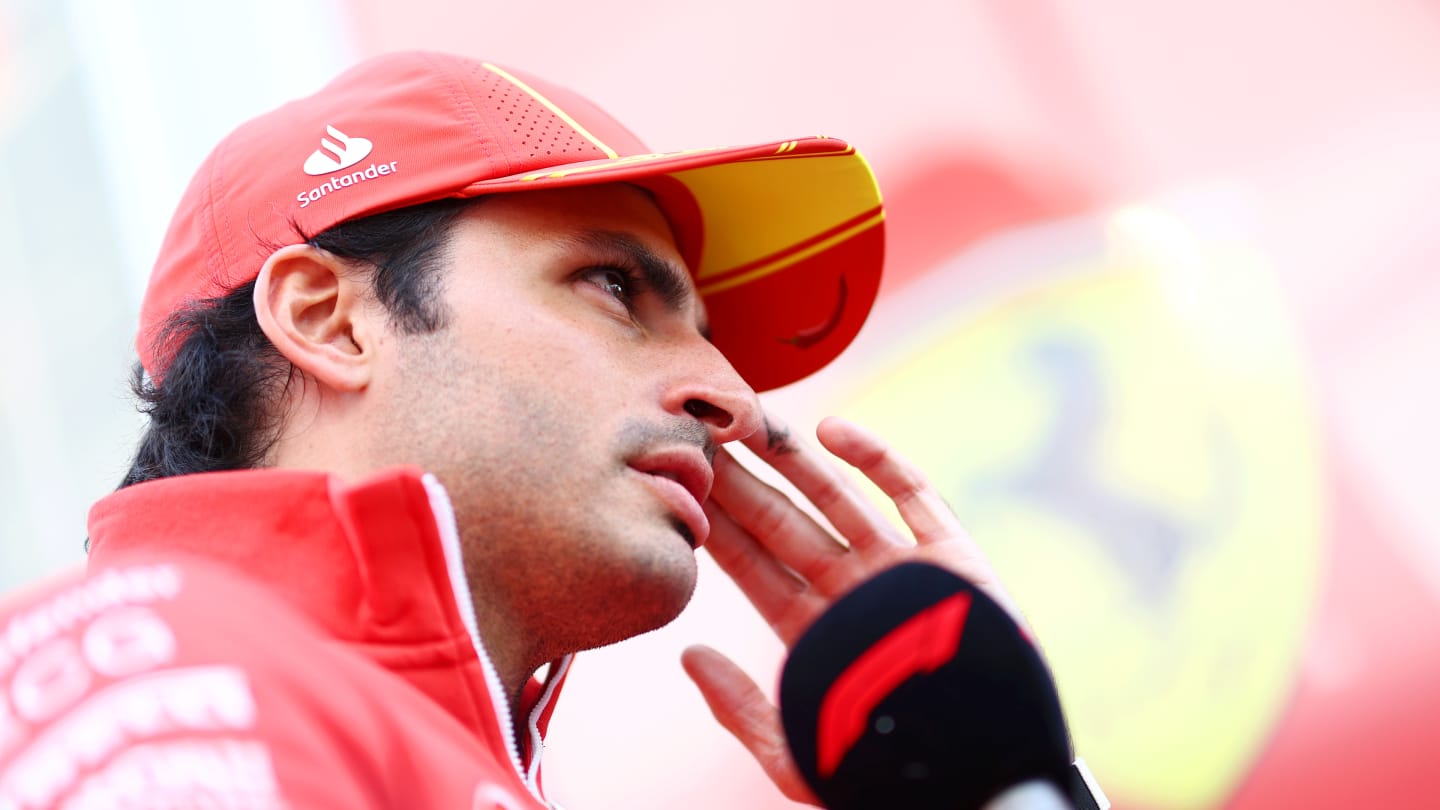 SUZUKA, JAPAN - APRIL 04: Carlos Sainz of Spain and Ferrari looks on in the Paddock during previews