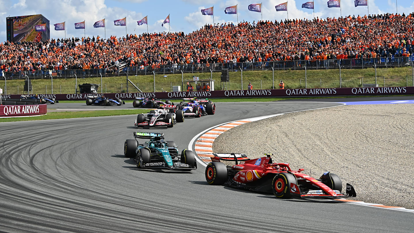 ZANDVOORT, NETHERLANDS - AUGUST 25: Carlos Sainz of Spain driving the (55) Ferrari SF-24 leads Lance Stroll of Canada driving the (18) Aston Martin AMR24 Mercedes during the F1 Grand Prix of Netherlands at Circuit Zandvoort on August 25, 2024 in Zandvoort, Netherlands. (Photo by James Sutton - Formula 1/Formula 1 via Getty Images)