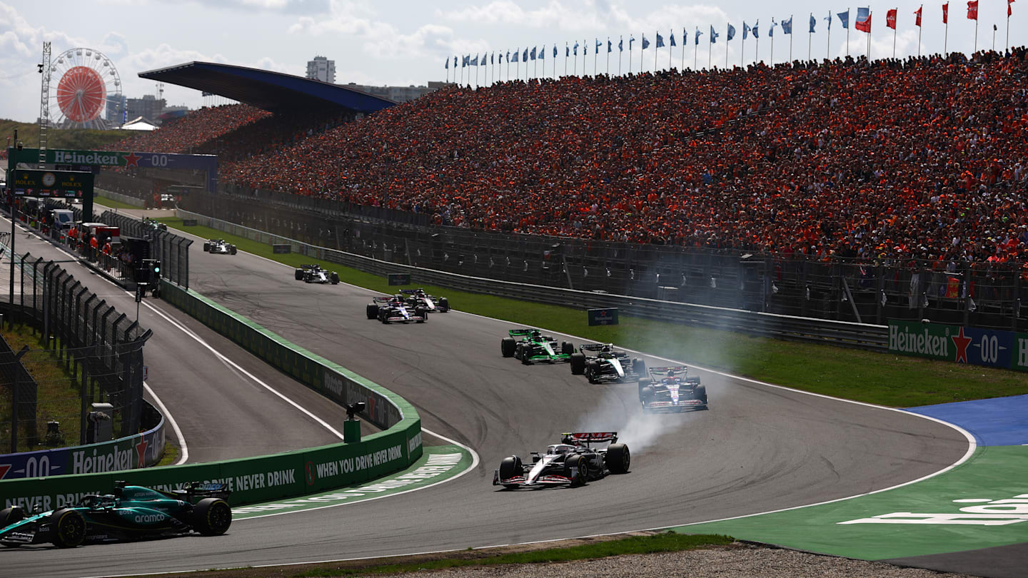 ZANDVOORT, NETHERLANDS - AUGUST 25: Lance Stroll of Canada driving the (18) Aston Martin AMR24 Mercedes leads Nico Hulkenberg of Germany driving the (27) Haas F1 VF-24 Ferrari during the F1 Grand Prix of Netherlands at Circuit Zandvoort on August 25, 2024 in Zandvoort, Netherlands. (Photo by Bryn Lennon - Formula 1/Formula 1 via Getty Images)