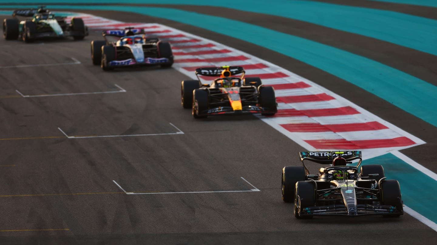ABU DHABI, UNITED ARAB EMIRATES - NOVEMBER 26: Lewis Hamilton of Great Britain driving the (44) Mercedes AMG Petronas F1 Team W14 leads Sergio Perez of Mexico driving the (11) Oracle Red Bull Racing RB18 during the F1 Grand Prix of Abu Dhabi at Yas Marina Circuit on November 26, 2023 in Abu Dhabi, United Arab Emirates. (Photo by Dan Istitene - Formula 1/Formula 1 via Getty Images)