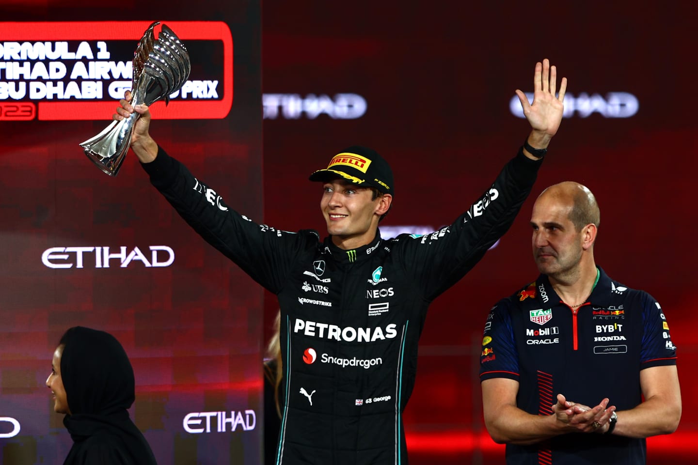 ABU DHABI, UNITED ARAB EMIRATES - NOVEMBER 26: Third placed George Russell of Great Britain and Mercedes celebrates on the podium during the F1 Grand Prix of Abu Dhabi at Yas Marina Circuit on November 26, 2023 in Abu Dhabi, United Arab Emirates. (Photo by Clive Rose/Getty Images)