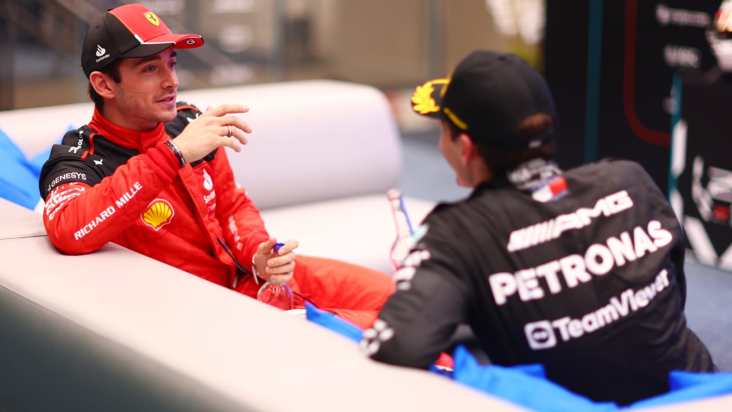 ABU DHABI, UNITED ARAB EMIRATES - NOVEMBER 26: Second placed Charles Leclerc of Monaco and Ferrari talks to Third placed George Russell of Great Britain and Mercedes in the cool down room during the F1 Grand Prix of Abu Dhabi at Yas Marina Circuit on November 26, 2023 in Abu Dhabi, United Arab Emirates. (Photo by Dan Istitene - Formula 1/Formula 1 via Getty Images)