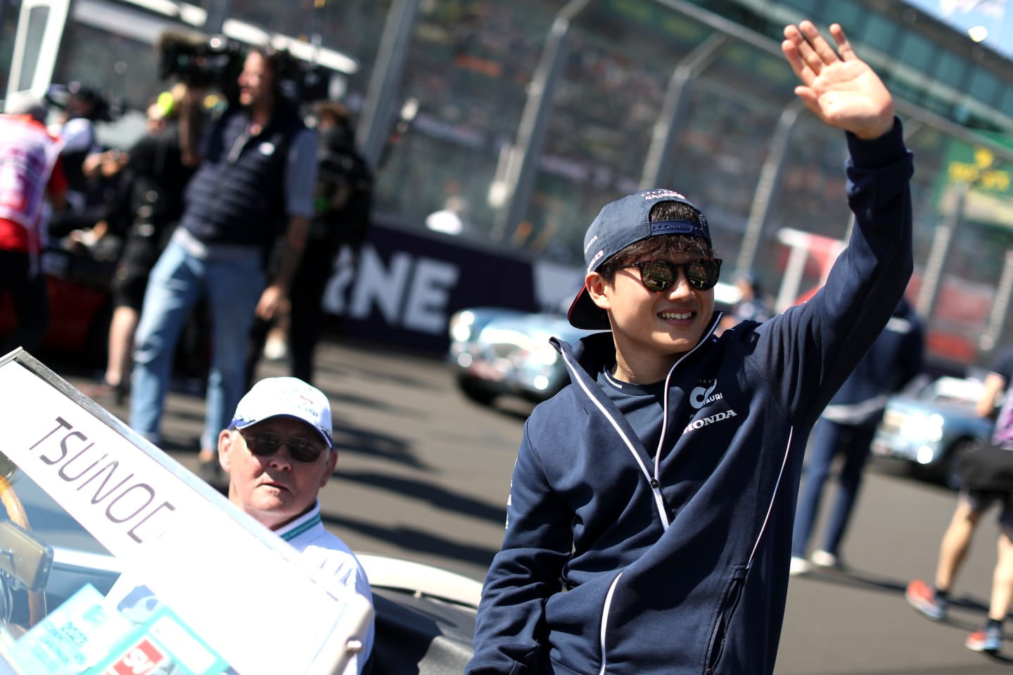 MELBOURNE, AUSTRALIA - APRIL 02: Yuki Tsunoda of Japan and Scuderia AlphaTauri waves to the crowd on the drivers parade prior to the F1 Grand Prix of Australia at Albert Park Grand Prix Circuit on April 02, 2023 Australia. (Photo by Peter Fox/Getty Images)