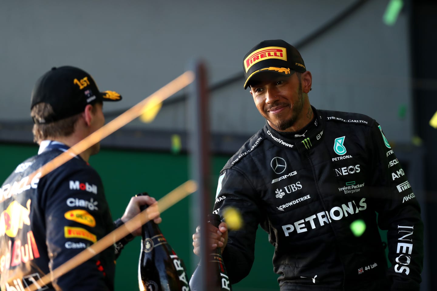 MELBOURNE, AUSTRALIA - APRIL 02: Race winner Max Verstappen of the Netherlands and Oracle Red Bull Racing and  Second placed Lewis Hamilton of Great Britain celebrate on the podium during the F1 Grand Prix of Australia at Albert Park Grand Prix Circuit on April 02, 2023 in Melbourne, Australia. (Photo by Peter Fox/Getty Images)