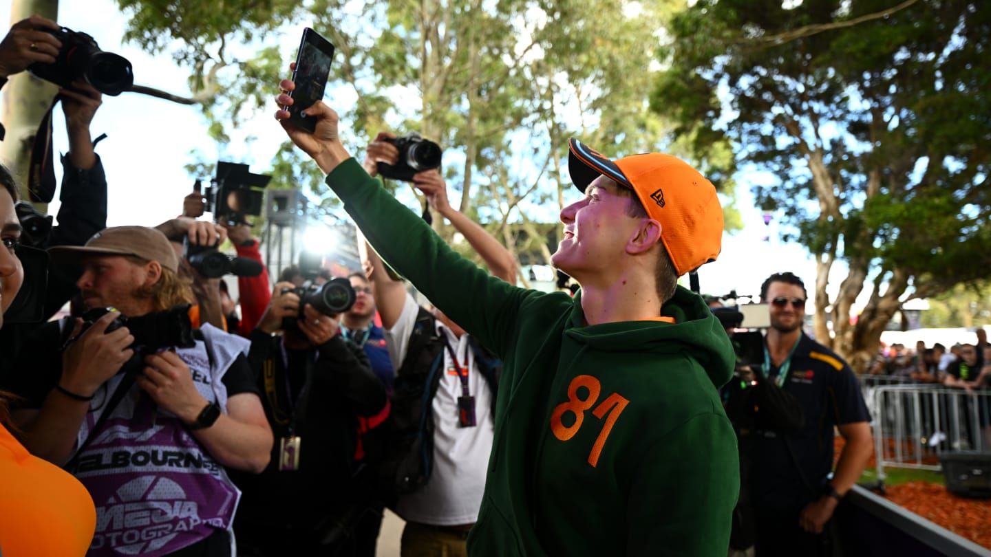 MELBOURNE, AUSTRALIA - MARCH 30: Oscar Piastri of Australia and McLaren greets fans on the