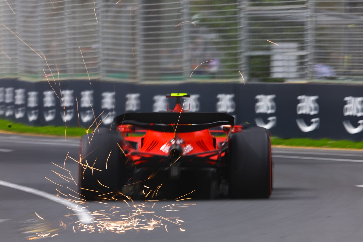 MELBOURNE, AUSTRALIA - APRIL 01: Sparks fly behind Carlos Sainz of Spain driving (55) the Ferrari