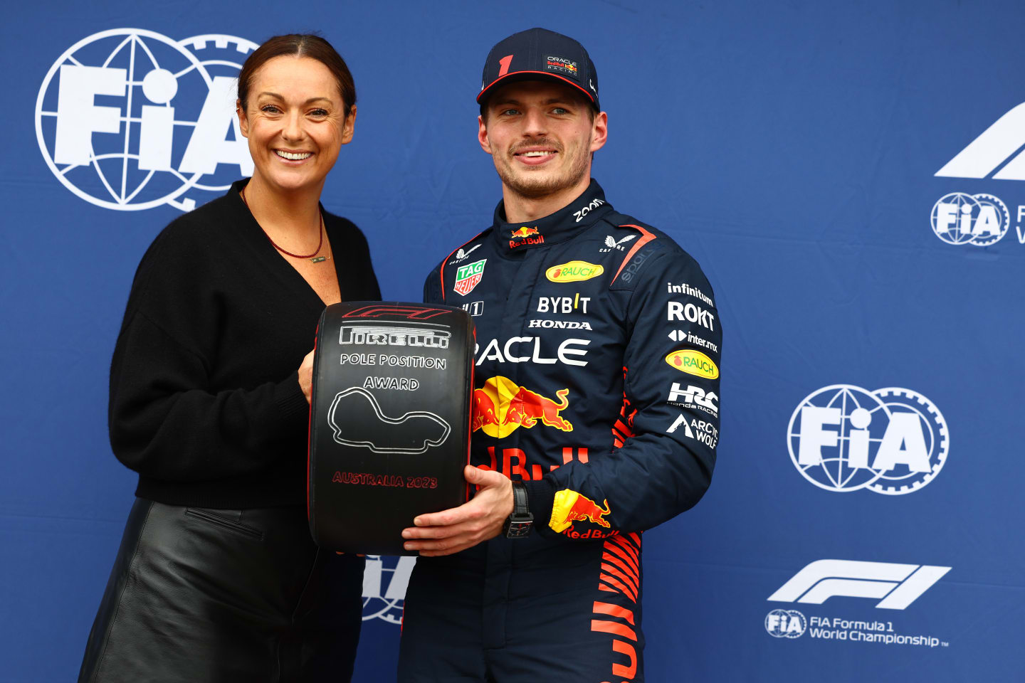 MELBOURNE, AUSTRALIA - APRIL 01: Pole position qualifier Max Verstappen of the Netherlands and Oracle Red Bull Racing is presented with the Pirelli Pole Position trophy by Celeste Barber in parc ferme during qualifying ahead of the F1 Grand Prix of Australia at Albert Park Grand Prix Circuit on April 01, 2023 in Melbourne, Australia. (Photo by Mark Thompson/Getty Images)