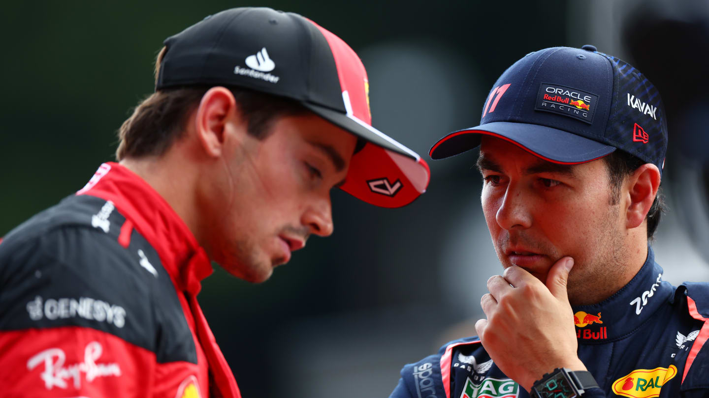 SPA, BELGIUM - JULY 28: Third placed qualifier Sergio Perez of Mexico and Oracle Red Bull Racing and Second placed qualifier Charles Leclerc of Monaco and Ferrari talk in parc ferme during qualifying ahead of the F1 Grand Prix of Belgium at Circuit de Spa-Francorchamps on July 28, 2023 in Spa, Belgium. (Photo by Dan Istitene - Formula 1/Formula 1 via Getty Images)
