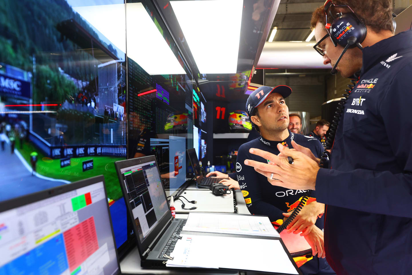 SPA, BELGIUM - JULY 29: Sergio Perez of Mexico and Oracle Red Bull Racing talks with race engineer