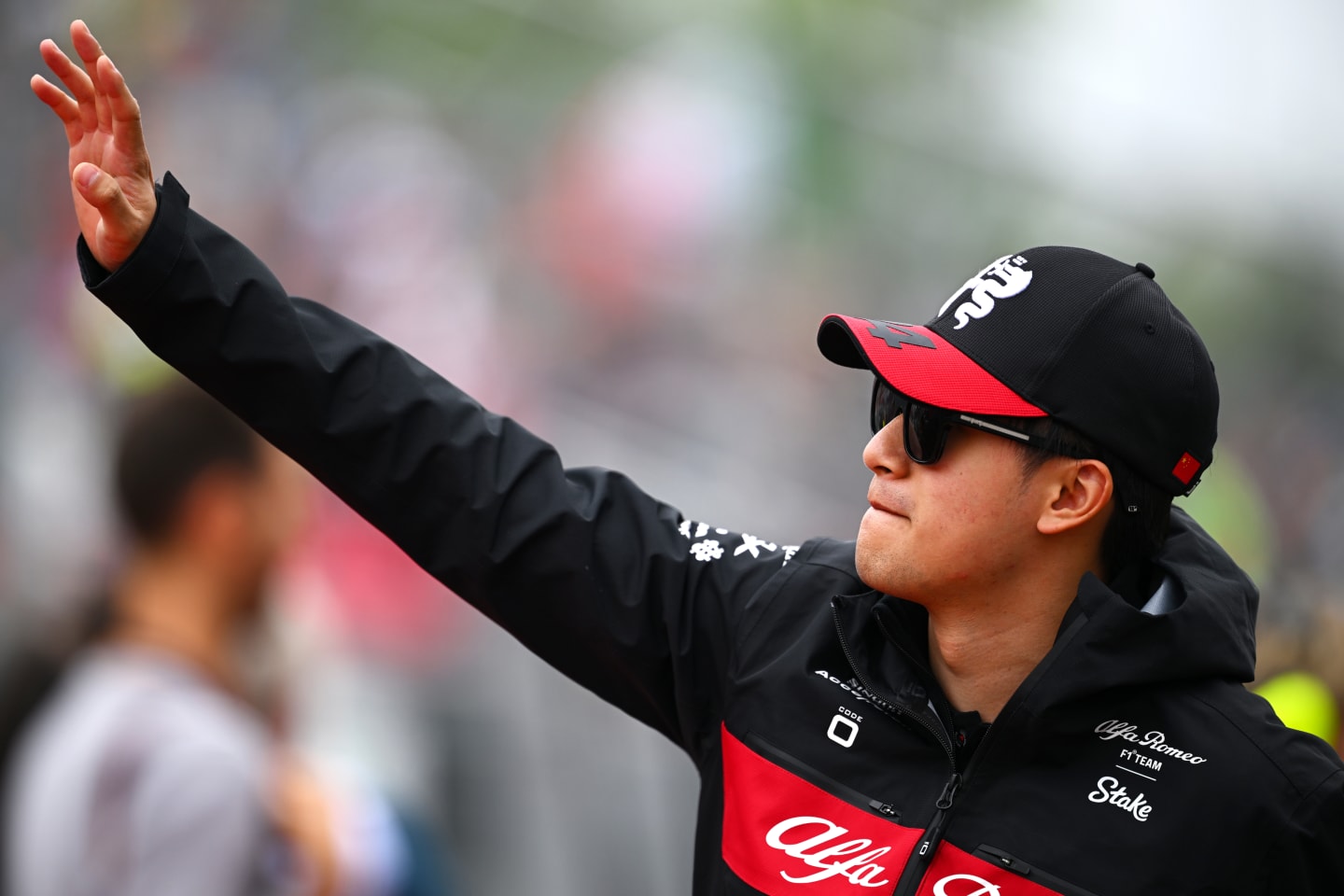 MONTREAL, QUEBEC - JUNE 18: Zhou Guanyu of China and Alfa Romeo F1 waves to the crowd on the drivers parade prior to the F1 Grand Prix of Canada at Circuit Gilles Villeneuve on June 18, 2023 in Montreal, Quebec. (Photo by Clive Mason/Getty Images)