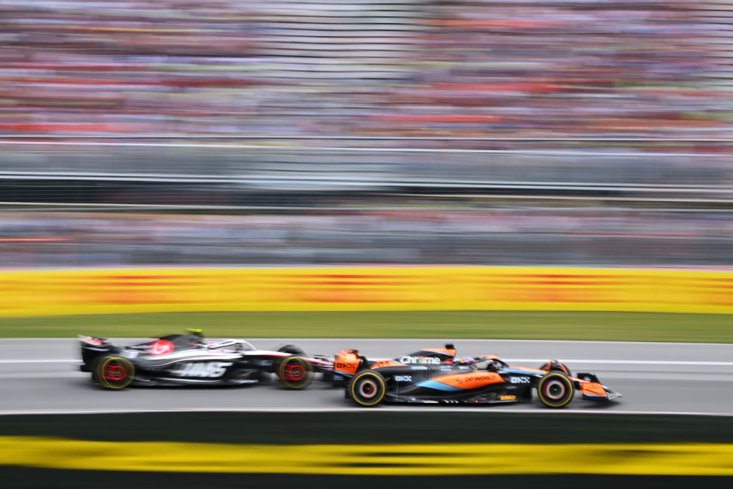 MONTREAL, QUEBEC - JUNE 18: Oscar Piastri of Australia driving the (81) McLaren MCL60 Mercedes and Nico Hulkenberg of Germany driving the (27) Haas F1 VF-23 Ferrari battle for position during the F1 Grand Prix of Canada at Circuit Gilles Villeneuve on June 18, 2023 in Montreal, Quebec. (Photo by Dan Mullan/Getty Images)