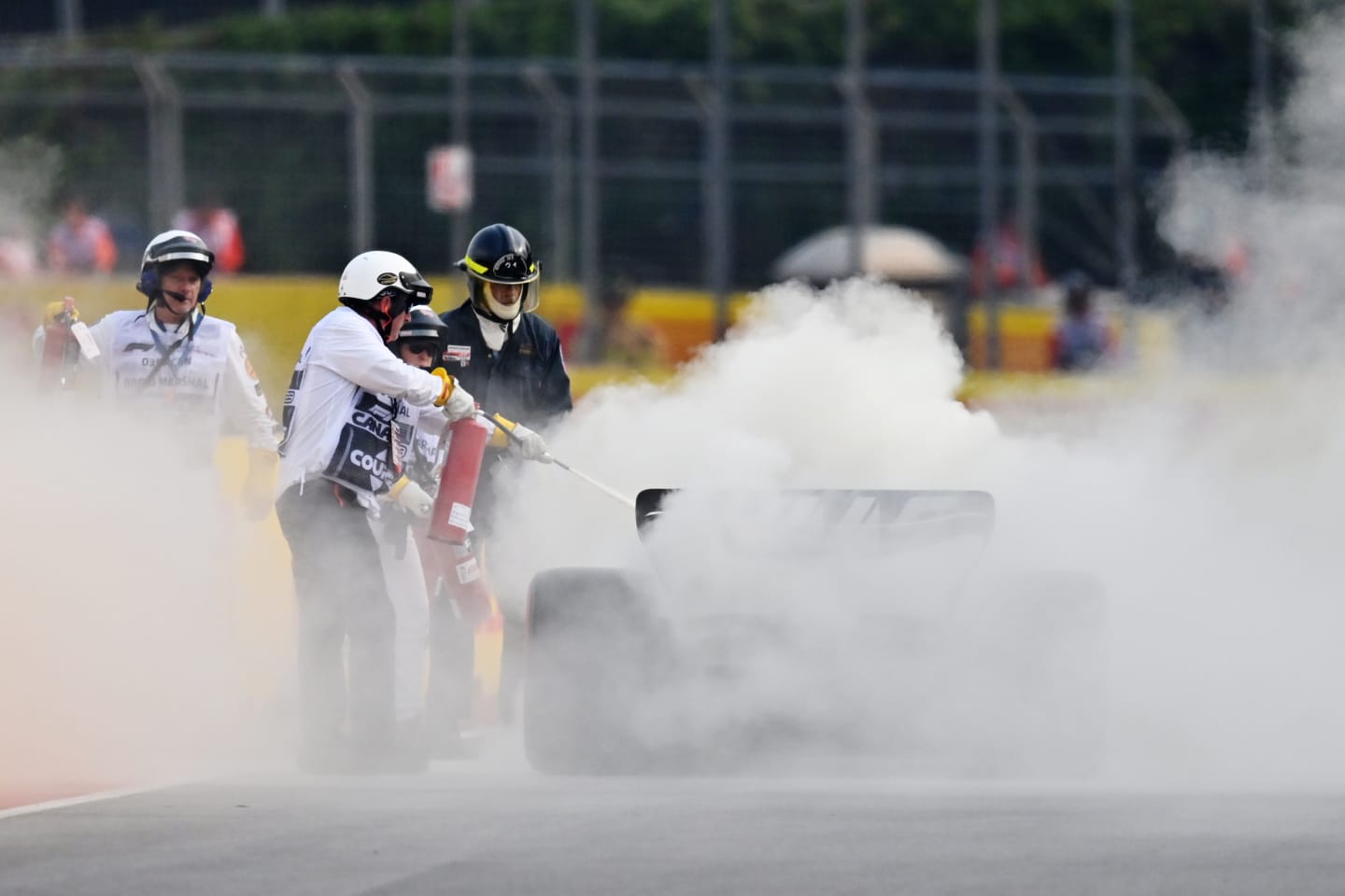 MONTREAL, QUEBEC - JUNE 16: Track marshals use fire extinguishers on the car of Nico Hulkenberg of Germany and Haas F1 during practice ahead of the F1 Grand Prix of Canada at Circuit Gilles Villeneuve on June 16, 2023 in Montreal, Quebec. (Photo by Dan Mullan/Getty Images)