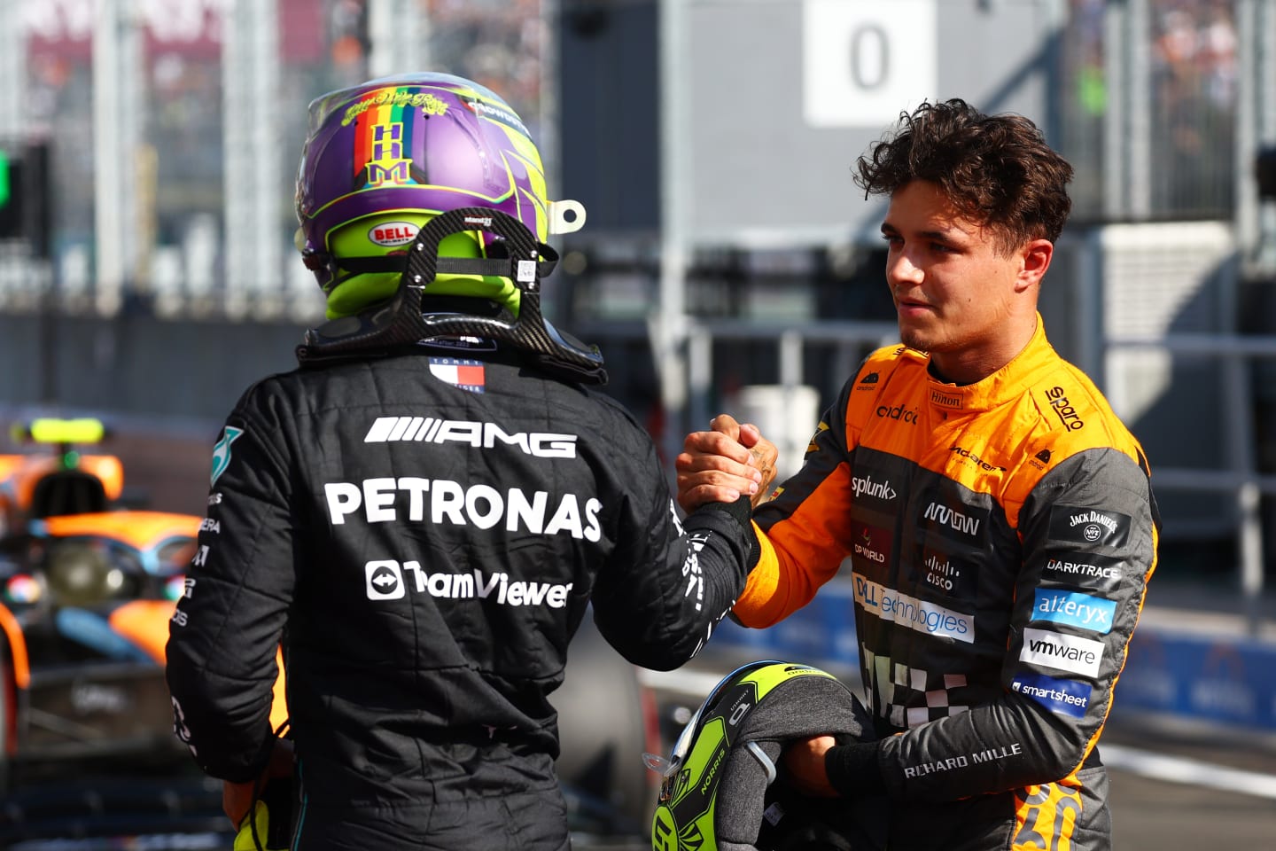 BUDAPEST, HUNGARY - JULY 22: Pole position qualifier Lewis Hamilton of Great Britain and Mercedes and Third placed qualifier Lando Norris of Great Britain and McLaren talk in parc ferme during qualifying ahead of the F1 Grand Prix of Hungary at Hungaroring on July 22, 2023 in Budapest, Hungary. (Photo by Mark Thompson/Getty Images)
