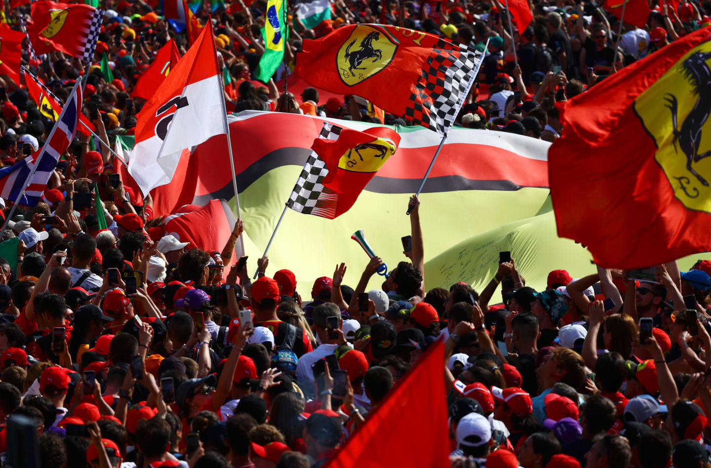 MONZA, ITALY - SEPTEMBER 03: Ferrari fans wave flags at the podium celebrations during the F1 Grand