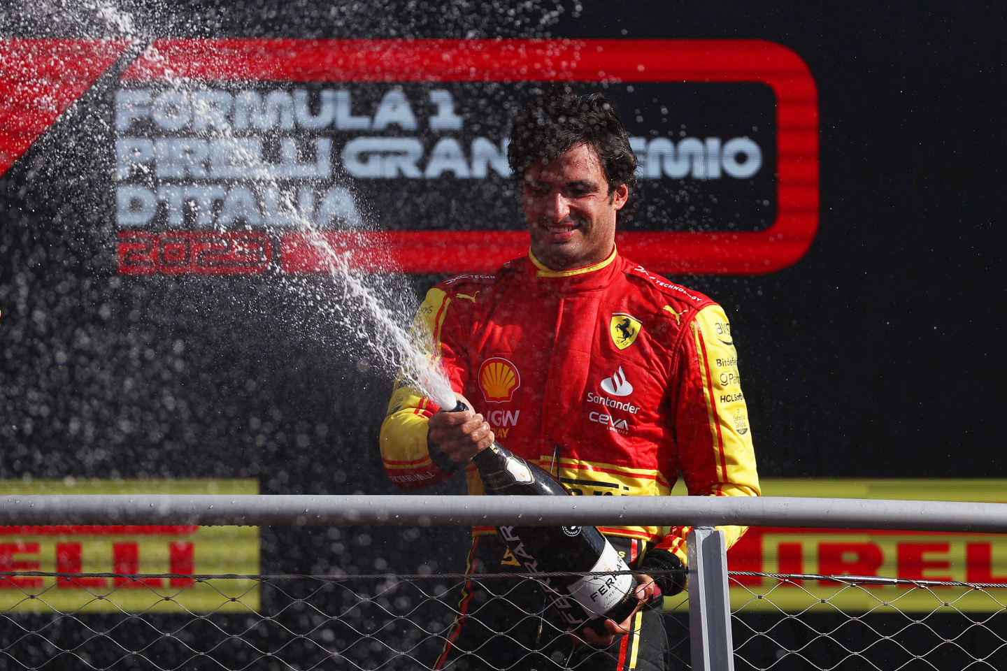 MONZA, ITALY - SEPTEMBER 03: Third placed Carlos Sainz of Spain and Ferrari celebrates on the podium during the F1 Grand Prix of Italy at Autodromo Nazionale Monza on September 03, 2023 in Monza, Italy. (Photo by Ryan Pierse/Getty Images)