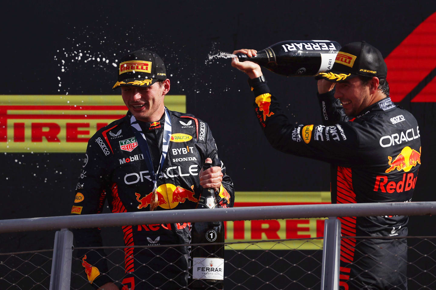 MONZA, ITALY - SEPTEMBER 03: Race winner Max Verstappen of the Netherlands and Oracle Red Bull Racing and Second placed Sergio Perez of Mexico and Oracle Red Bull Racing celebrate on the podium during the F1 Grand Prix of Italy at Autodromo Nazionale Monza on September 03, 2023 in Monza, Italy. (Photo by Ryan Pierse/Getty Images)
