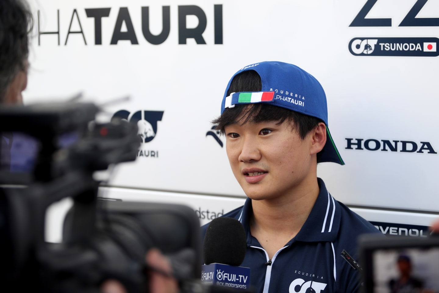 MONZA, ITALY - SEPTEMBER 01: Yuki Tsunoda of Japan and Scuderia AlphaTauri talks to the media in the Paddock after practice ahead of the F1 Grand Prix of Italy at Autodromo Nazionale Monza on September 01, 2023 in Monza, Italy. (Photo by Peter Fox/Getty Images)