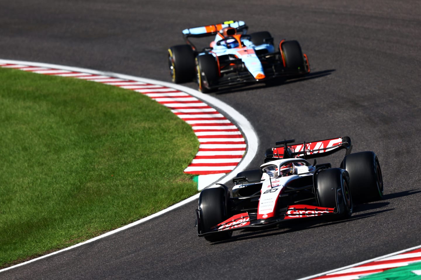 SUZUKA, JAPAN - SEPTEMBER 24: Kevin Magnussen of Denmark driving the (20) Haas F1 VF-23 Ferrari leads Logan Sargeant of United States driving the (2) Williams FW45 Mercedes during the F1 Grand Prix of Japan at Suzuka International Racing Course on September 24, 2023 in Suzuka, Japan. (Photo by Clive Rose/Getty Images)