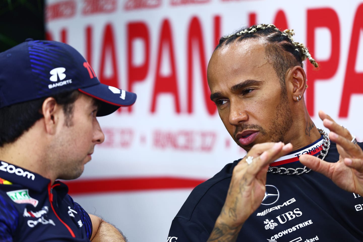 SUZUKA, JAPAN - SEPTEMBER 21: Lewis Hamilton of Great Britain and Mercedes talks with Sergio Perez of Mexico and Oracle Red Bull Racing in the Drivers Press Conference during previews ahead of the F1 Grand Prix of Japan at Suzuka International Racing Course on September 21, 2023 in Suzuka, Japan. (Photo by Clive Rose/Getty Images)