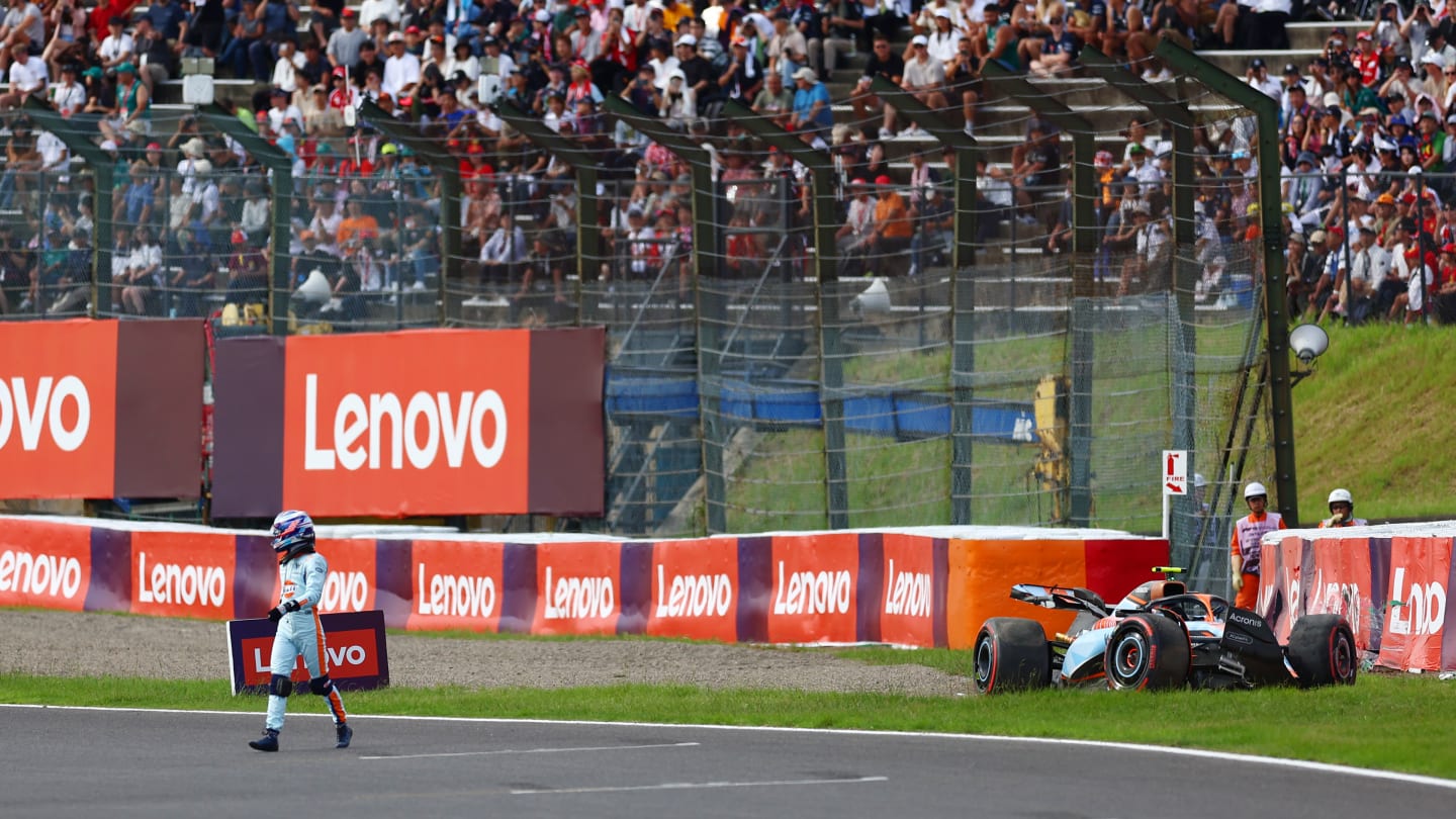 SUZUKA, JAPAN - SEPTEMBER 23: Logan Sargeant of United States and Williams walks from his car after