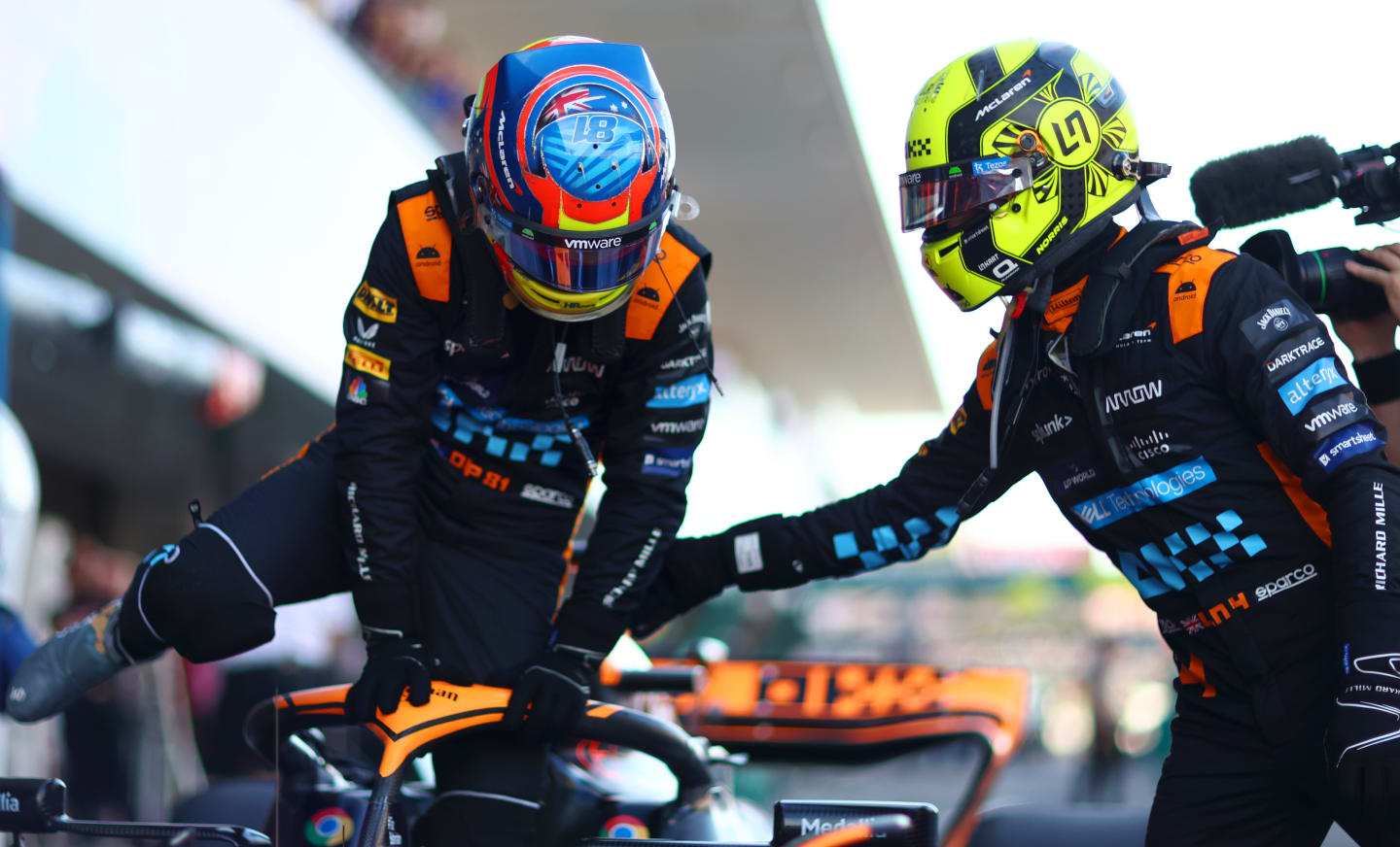 SUZUKA, JAPAN - SEPTEMBER 23:  Second placed qualifier Oscar Piastri of Australia and McLaren is congratulated by Third placed qualifier Lando Norris of Great Britain and McLaren as he climbs out of his car in parc ferme during qualifying ahead of the F1 Grand Prix of Japan at Suzuka International Racing Course on September 23, 2023 in Suzuka, Japan. (Photo by Dan Istitene - Formula 1/Formula 1 via Getty Images)