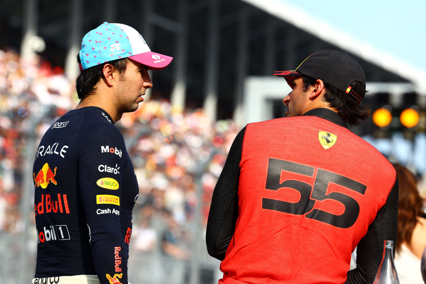 MIAMI, FLORIDA - MAY 06: Pole position qualifier Sergio Perez of Mexico and Oracle Red Bull Racing and Third placed qualifier Carlos Sainz of Spain and Ferrari talk in parc ferme during qualifying ahead of the F1 Grand Prix of Miami at Miami International Autodrome on May 06, 2023 in Miami, Florida. (Photo by Mark Thompson/Getty Images)