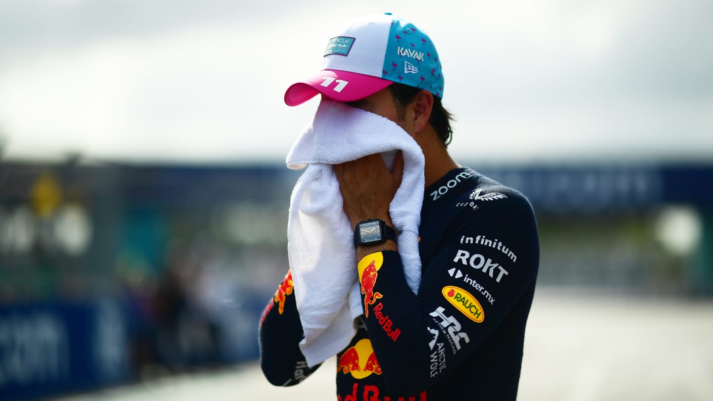 MIAMI, FLORIDA - MAY 06: Pole position qualifier Sergio Perez of Mexico and Oracle Red Bull Racing wipes his face with a towel in parc ferme during qualifying ahead of the F1 Grand Prix of Miami at Miami International Autodrome on May 06, 2023 in Miami, Florida. (Photo by Mario Renzi - Formula 1/Formula 1 via Getty Images)