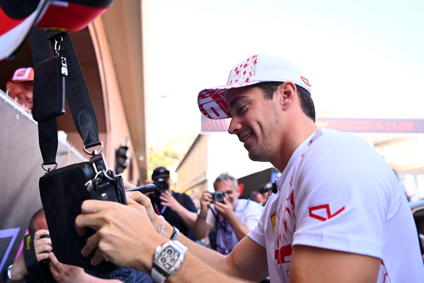 MONTE-CARLO, MONACO - MAY 26: Charles Leclerc of Monaco and Ferrari signs autographs for fans in