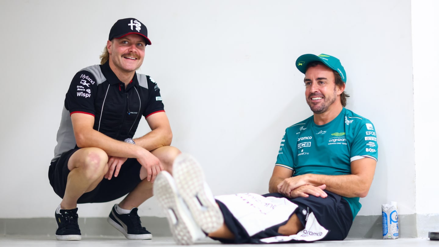LUSAIL CITY, QATAR - OCTOBER 08: Fernando Alonso of Spain and Aston Martin F1 Team and Valtteri Bottas of Finland and Alfa Romeo F1 talk on the drivers parade prior to the F1 Grand Prix of Qatar at Lusail International Circuit on October 08, 2023 in Lusail City, Qatar. (Photo by Dan Istitene - Formula 1/Formula 1 via Getty Images)