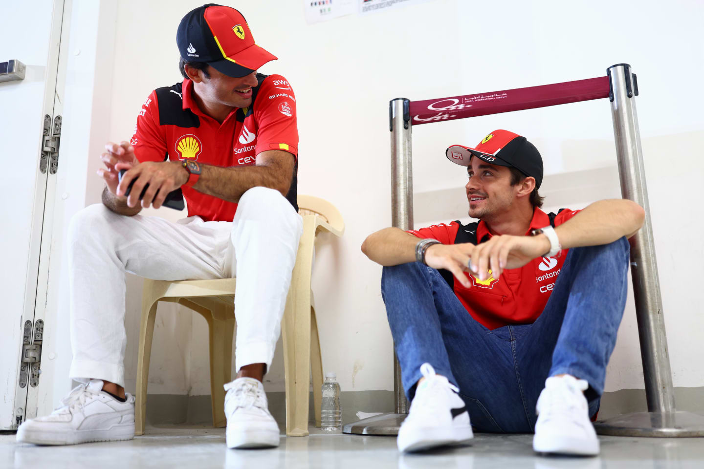 LUSAIL CITY, QATAR - OCTOBER 08: Carlos Sainz of Spain and Ferrari and Charles Leclerc of Monaco and Ferrari talk on the drivers parade prior to the F1 Grand Prix of Qatar at Lusail International Circuit on October 08, 2023 in Lusail City, Qatar. (Photo by Dan Istitene - Formula 1/Formula 1 via Getty Images)