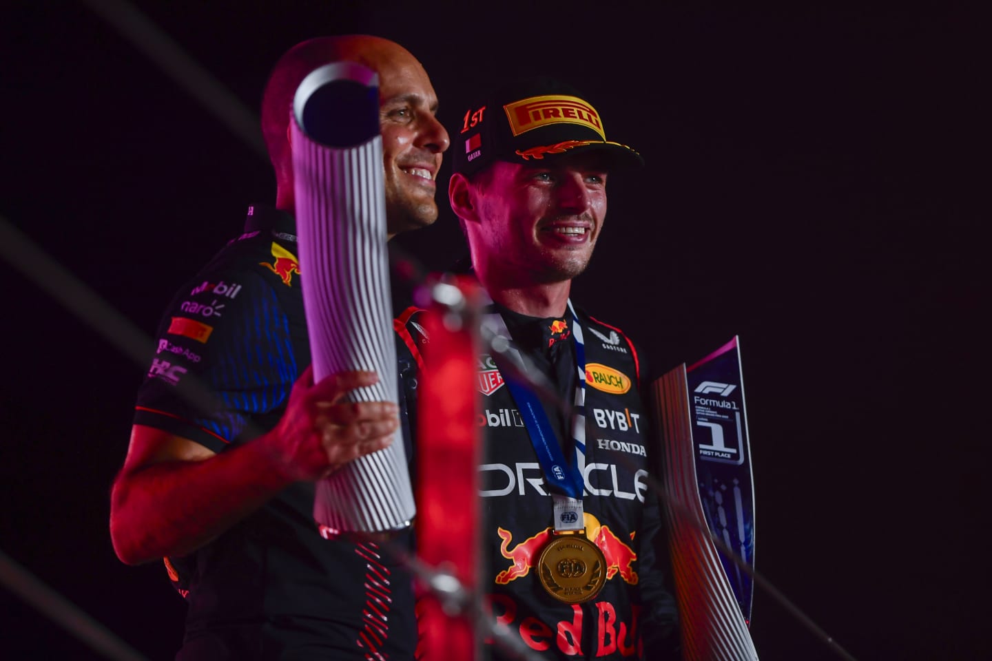 LUSAIL CITY, QATAR - OCTOBER 08: Race winner Max Verstappen of the Netherlands and Oracle Red Bull Racing and race engineer Gianpiero Lambiase celebrate on the podium during the F1 Grand Prix of Qatar at Lusail International Circuit on October 08, 2023 in Lusail City, Qatar. (Photo by Rudy Carezzevoli/Getty Images)
