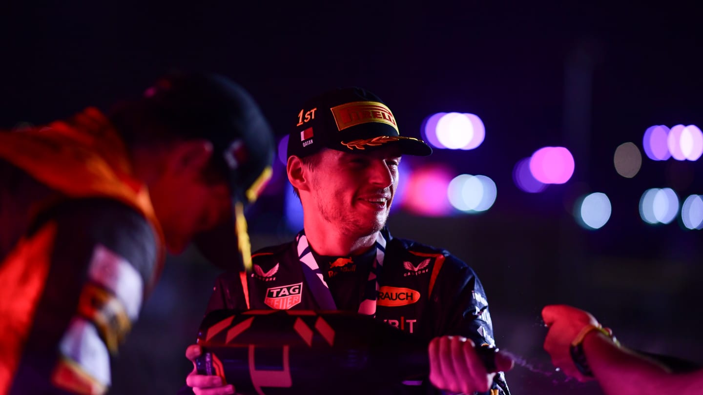 LUSAIL CITY, QATAR - OCTOBER 08: Race winner Max Verstappen of the Netherlands and Oracle Red Bull Racing celebrates on the podium during the F1 Grand Prix of Qatar at Lusail International Circuit on October 08, 2023 in Lusail City, Qatar. (Photo by Mario Renzi - Formula 1/Formula 1 via Getty Images)