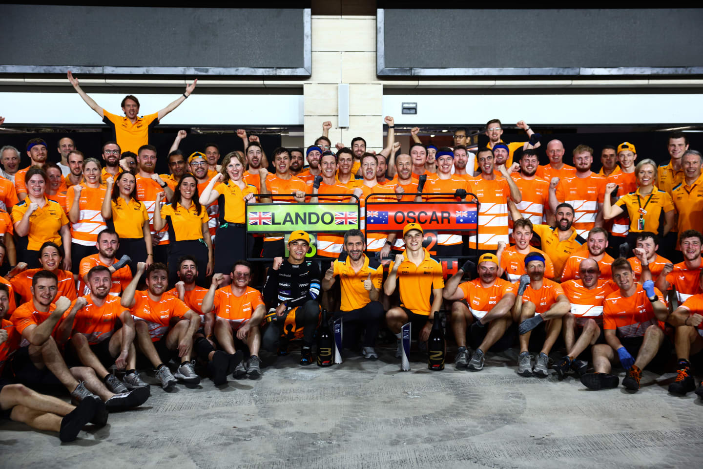 LUSAIL CITY, QATAR - OCTOBER 08: Second placed Oscar Piastri of Australia and McLaren and Third placed Lando Norris of Great Britain and McLaren celebrate with their team after the F1 Grand Prix of Qatar at Lusail International Circuit on October 08, 2023 in Lusail City, Qatar. (Photo by Clive Rose/Getty Images)