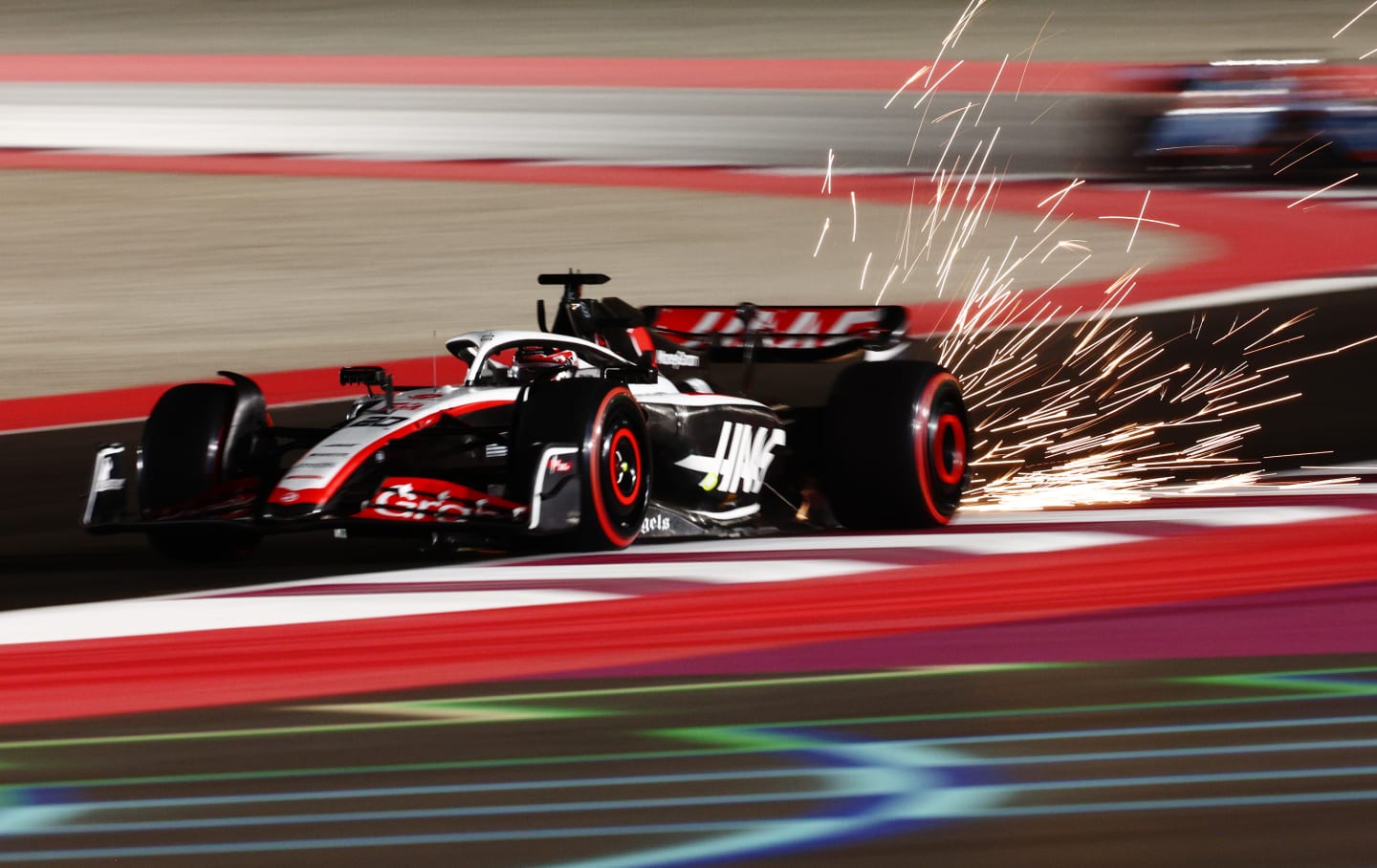 LUSAIL CITY, QATAR - OCTOBER 06: Sparks fly behind Kevin Magnussen of Denmark driving the (20) Haas F1 VF-23 Ferrari during qualifying ahead of the F1 Grand Prix of Qatar at Lusail International Circuit on October 06, 2023 in Lusail City, Qatar. (Photo by Clive Rose/Getty Images)