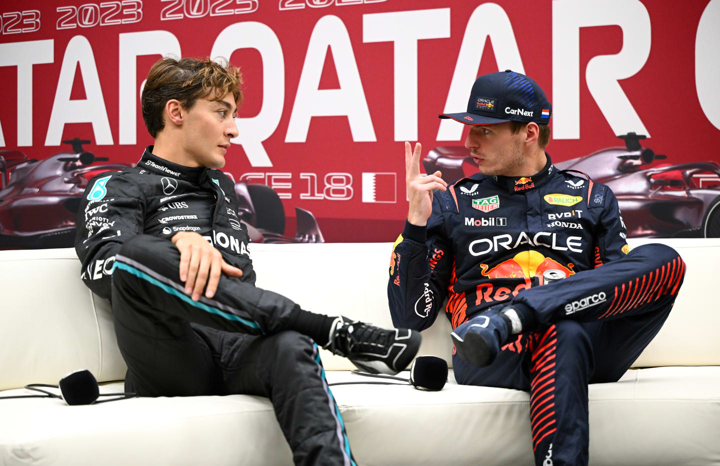 LUSAIL CITY, QATAR - OCTOBER 06: Pole position qualifier Max Verstappen of the Netherlands and Oracle Red Bull Racing and Second placed qualifier George Russell of Great Britain and Mercedes attend the press conference after qualifying ahead of the F1 Grand Prix of Qatar at Lusail International Circuit on October 06, 2023 in Lusail City, Qatar. (Photo by Clive Mason/Getty Images)