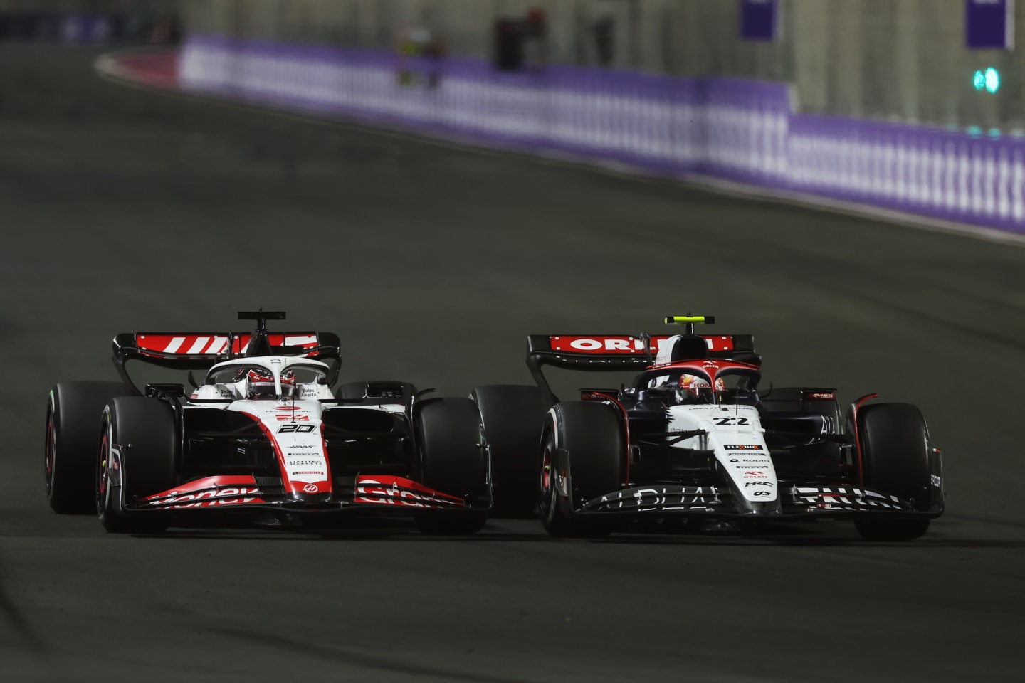 JEDDAH, SAUDI ARABIA - MARCH 19: Yuki Tsunoda of Japan driving the (22) Scuderia AlphaTauri AT04 leads Kevin Magnussen of Denmark driving the (20) Haas F1 VF-23 Ferrari during the F1 Grand Prix of Saudi Arabia at Jeddah Corniche Circuit on March 19, 2023 in Jeddah, Saudi Arabia. (Photo by Lars Baron/Getty Images)
