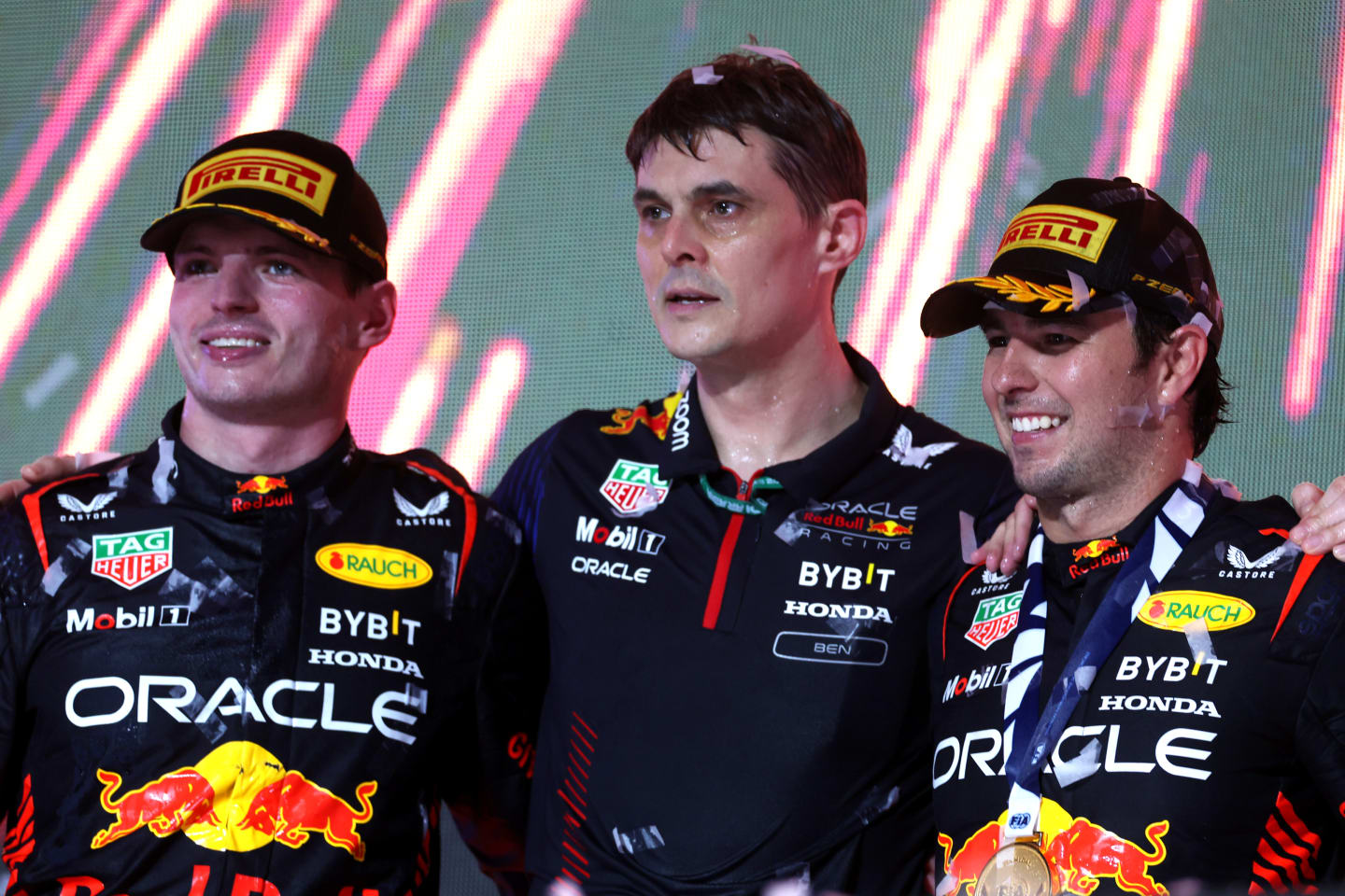 JEDDAH, SAUDI ARABIA - MARCH 19: Race winner Sergio Perez of Mexico and Oracle Red Bull Racing (R), Second placed Max Verstappen of the Netherlands and Oracle Red Bull Racing (L) and Ben Waterhouse, Head of Performance Engineering at Red Bull Racing, celebrate on the podium during the F1 Grand Prix of Saudi Arabia at Jeddah Corniche Circuit on March 19, 2023 in Jeddah, Saudi Arabia. (Photo by Lars Baron/Getty Images)