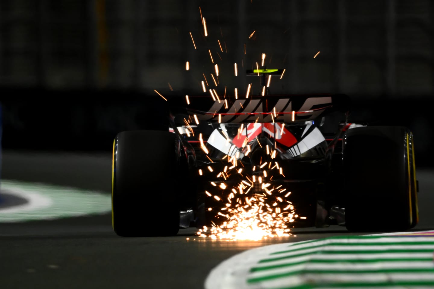 JEDDAH, SAUDI ARABIA - MARCH 17: Sparks fly behind Nico Hulkenberg of Germany driving the (27) Haas F1 VF-23 Ferrari during practice ahead of the F1 Grand Prix of Saudi Arabia at Jeddah Corniche Circuit on March 17, 2023 in Jeddah, Saudi Arabia. (Photo by Clive Mason/Getty Images)