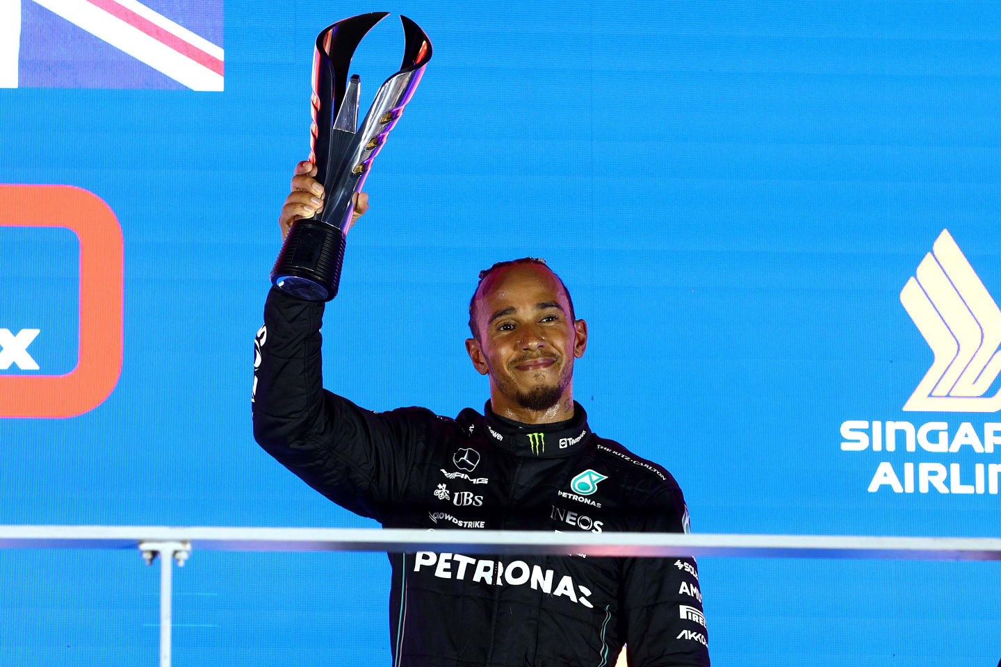 SINGAPORE, SINGAPORE - SEPTEMBER 17: Third placed Lewis Hamilton of Great Britain and Mercedes celebrates on the podium during the F1 Grand Prix of Singapore at Marina Bay Street Circuit on September 17, 2023 in Singapore, Singapore. (Photo by Clive Rose/Getty Images)