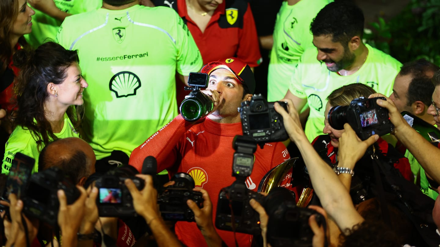 SINGAPORE, SINGAPORE - SEPTEMBER 17: Race winner Carlos Sainz of Spain and Ferrari celebrates with