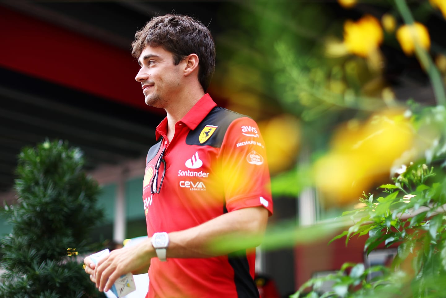SINGAPORE, SINGAPORE - SEPTEMBER 14: Charles Leclerc of Monaco and Ferrari walks in the Paddock