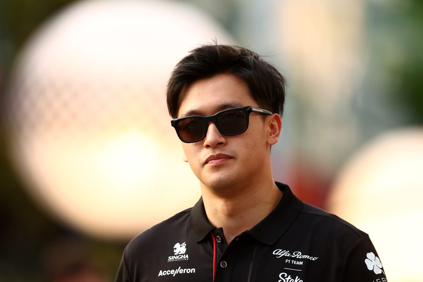 SINGAPORE, SINGAPORE - SEPTEMBER 14: Zhou Guanyu of China and Alfa Romeo F1 walks in the Paddock