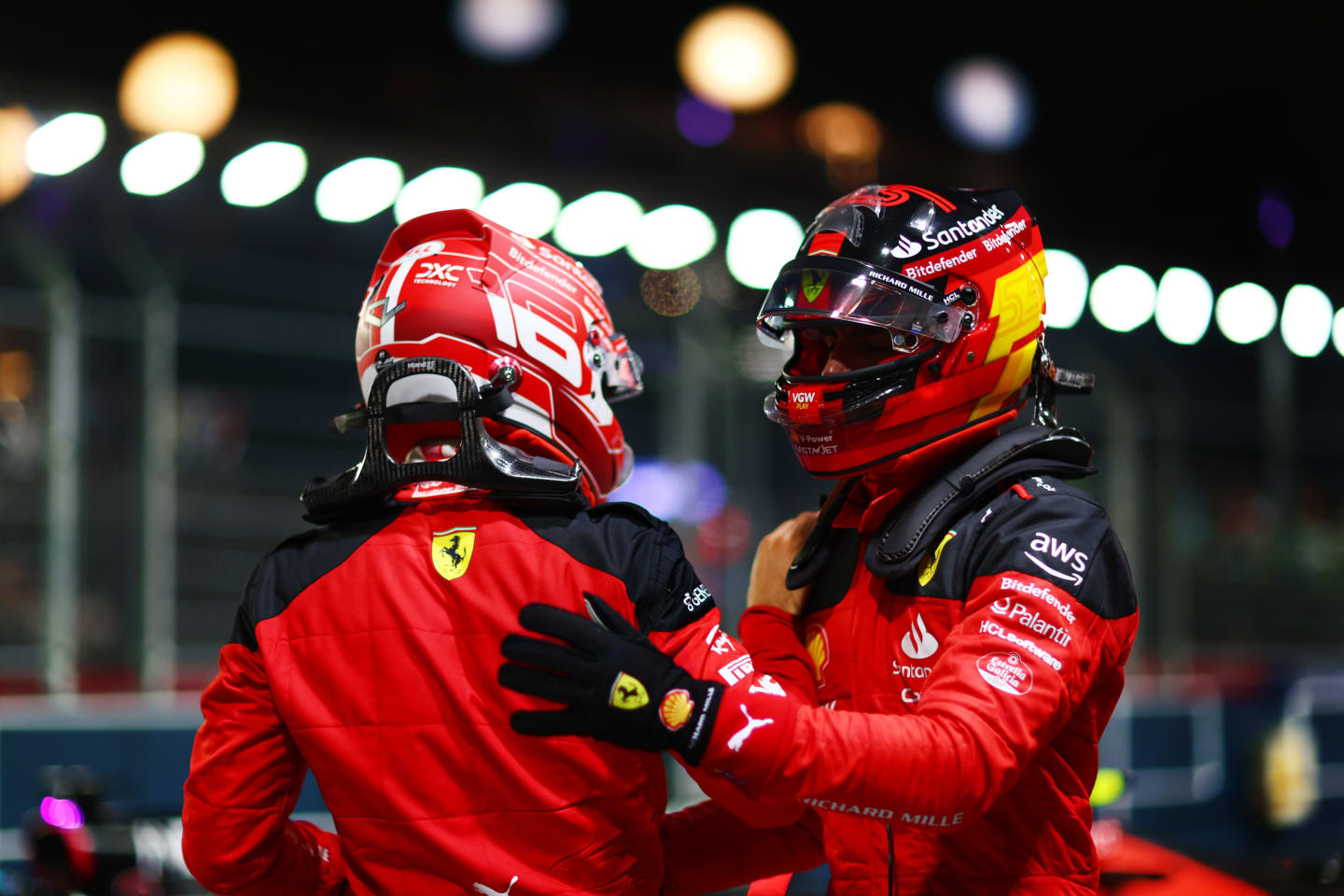SINGAPORE, SINGAPORE - SEPTEMBER 16: Pole position qualifier Carlos Sainz of Spain and Ferrari celebrates with team-mate and third placed qualifier Charles Leclerc of Monaco and Ferrari in parc ferme during qualifying ahead of the F1 Grand Prix of Singapore at Marina Bay Street Circuit on September 16, 2023 in Singapore, Singapore. (Photo by Dan Istitene - Formula 1/Formula 1 via Getty Images)