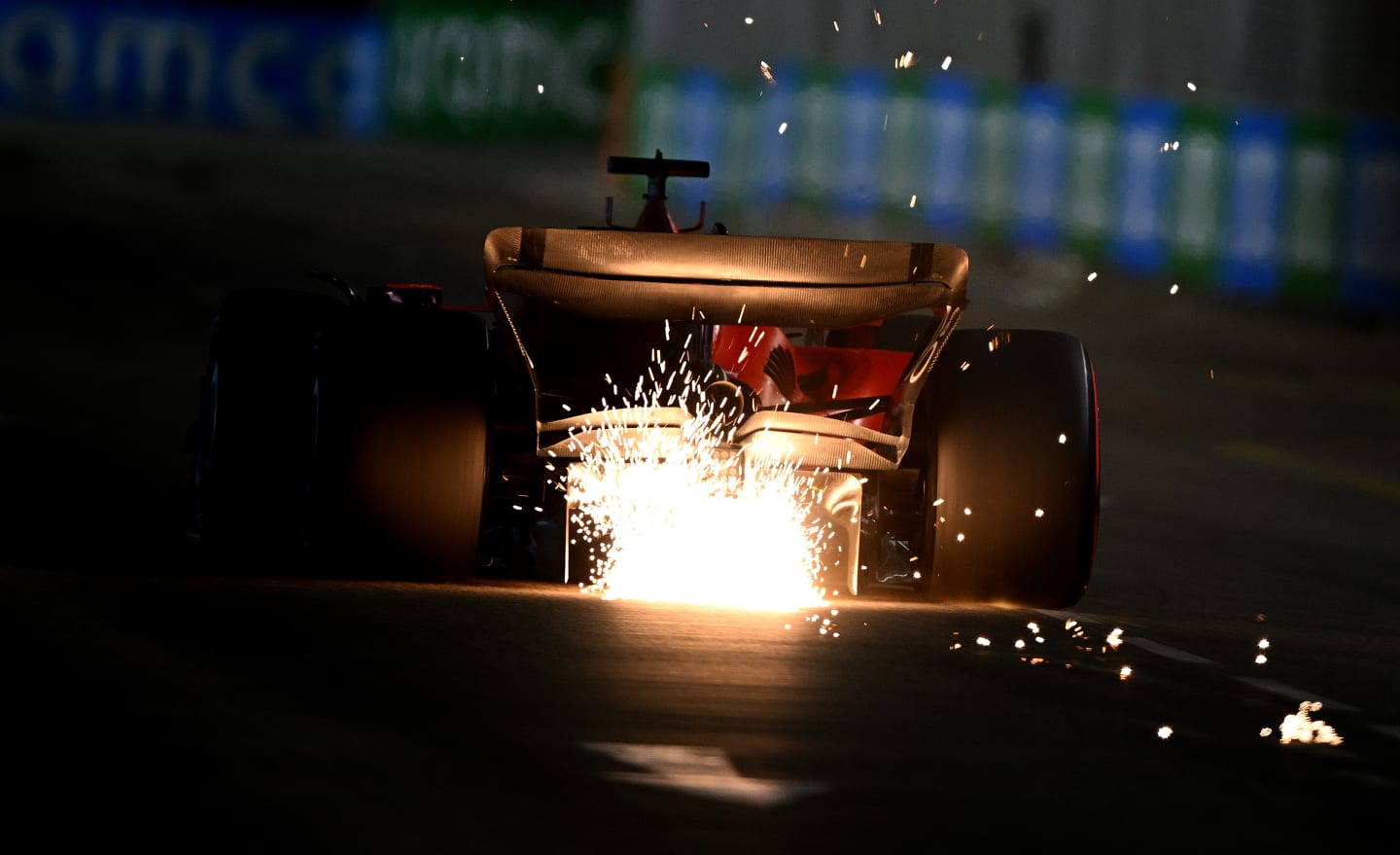 SINGAPORE, SINGAPORE - SEPTEMBER 16: Sparks fly behind Charles Leclerc of Monaco driving the (16) Ferrari SF-23 during qualifying ahead of the F1 Grand Prix of Singapore at Marina Bay Street Circuit on September 16, 2023 in Singapore, Singapore. (Photo by Clive Mason/Getty Images)