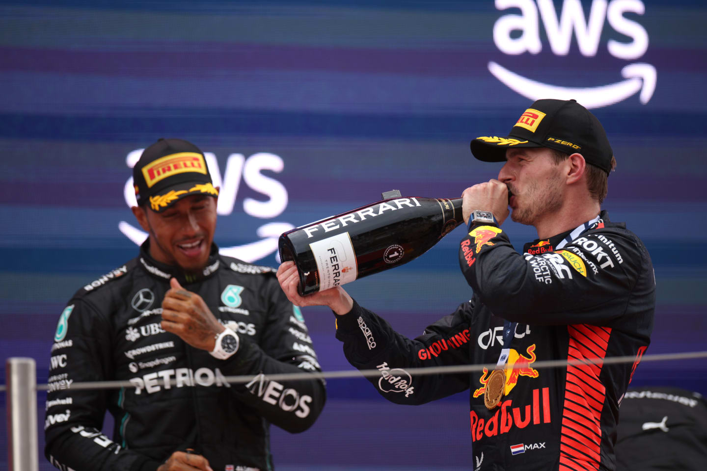 BARCELONA, SPAIN - JUNE 04: Race winner Max Verstappen of the Netherlands and Oracle Red Bull Racing and Second placed Lewis Hamilton of Great Britain and Mercedes celebrate on the podium during the F1 Grand Prix of Spain at Circuit de Barcelona-Catalunya on June 04, 2023 in Barcelona, Spain. (Photo by Adam Pretty/Getty Images)