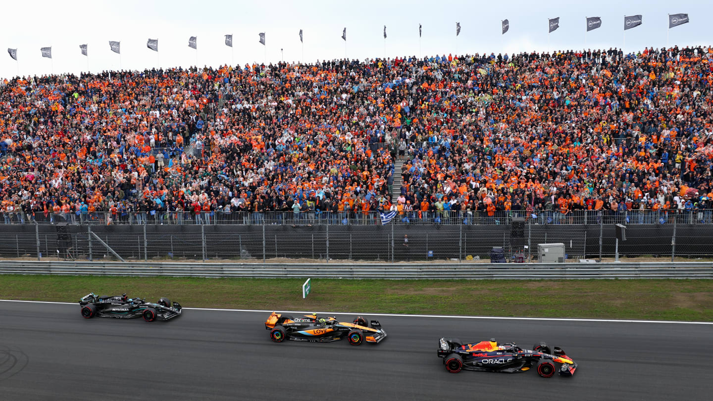 ZANDVOORT, NETHERLANDS - AUGUST 27: Max Verstappen of the Netherlands driving the (1) Oracle Red Bull Racing RB19 leads Lando Norris of Great Britain driving the (4) McLaren MCL60 Mercedes and George Russell of Great Britain driving the (63) Mercedes AMG Petronas F1 Team W14 into turn one at the start during the F1 Grand Prix of The Netherlands at Circuit Zandvoort on August 27, 2023 in Zandvoort, Netherlands. (Photo by Dan Istitene - Formula 1/Formula 1 via Getty Images)