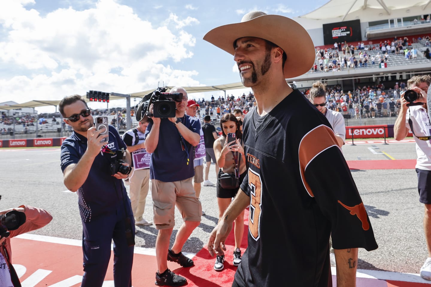 AUSTIN, TEXAS - OCTOBER 22: Daniel Ricciardo of Australia and Scuderia AlphaTauri looks on from the drivers parade prior to the F1 Grand Prix of United States at Circuit of The Americas on October 22, 2023 in Austin, Texas. (Photo by Chris Graythen/Getty Images)