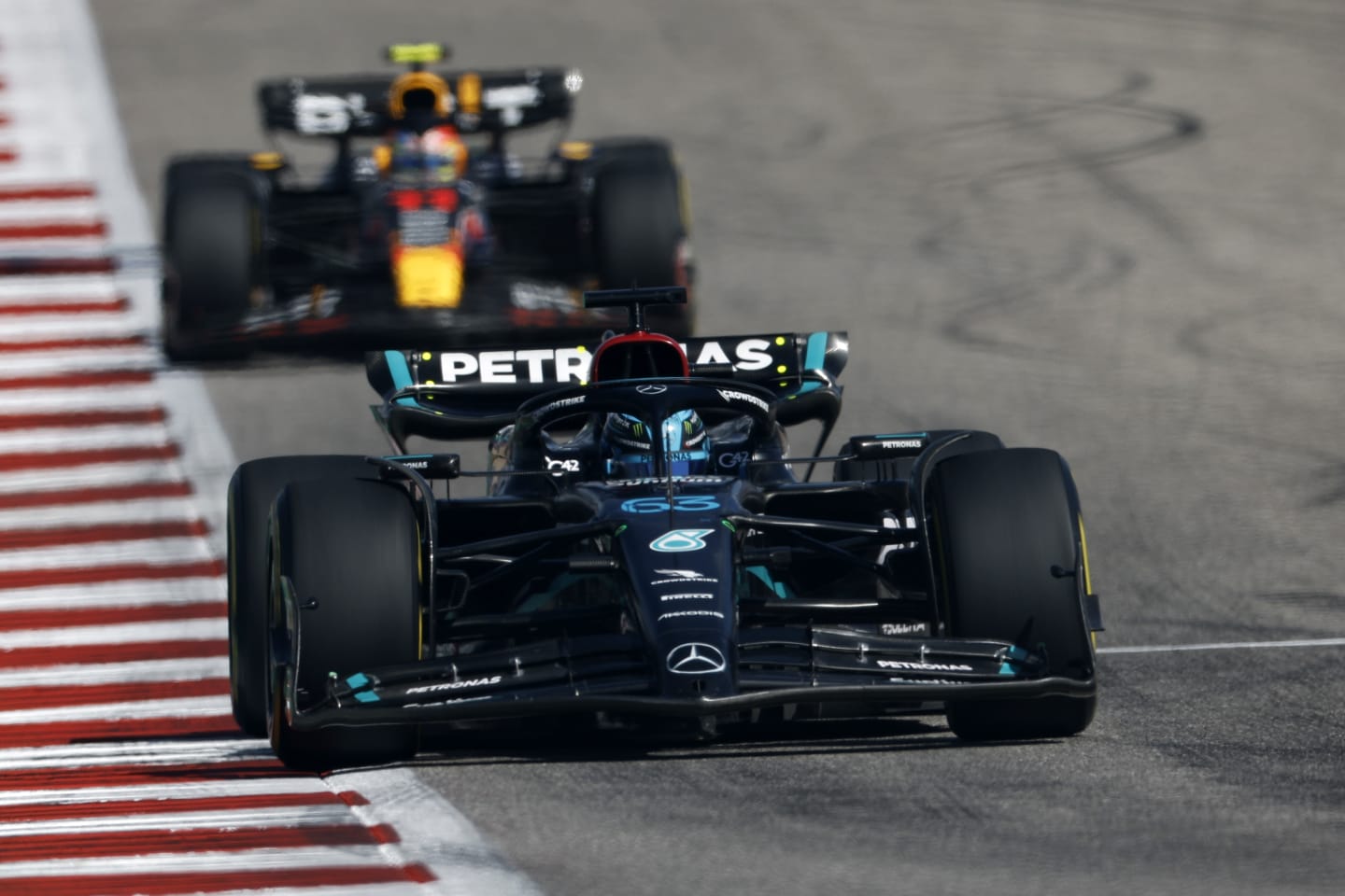 AUSTIN, TEXAS - OCTOBER 22: George Russell of Great Britain driving the (63) Mercedes AMG Petronas F1 Team W14 leads Sergio Perez of Mexico driving the (11) Oracle Red Bull Racing RB19 on track during the F1 Grand Prix of United States at Circuit of The Americas on October 22, 2023 in Austin, Texas. (Photo by Chris Graythen/Getty Images)