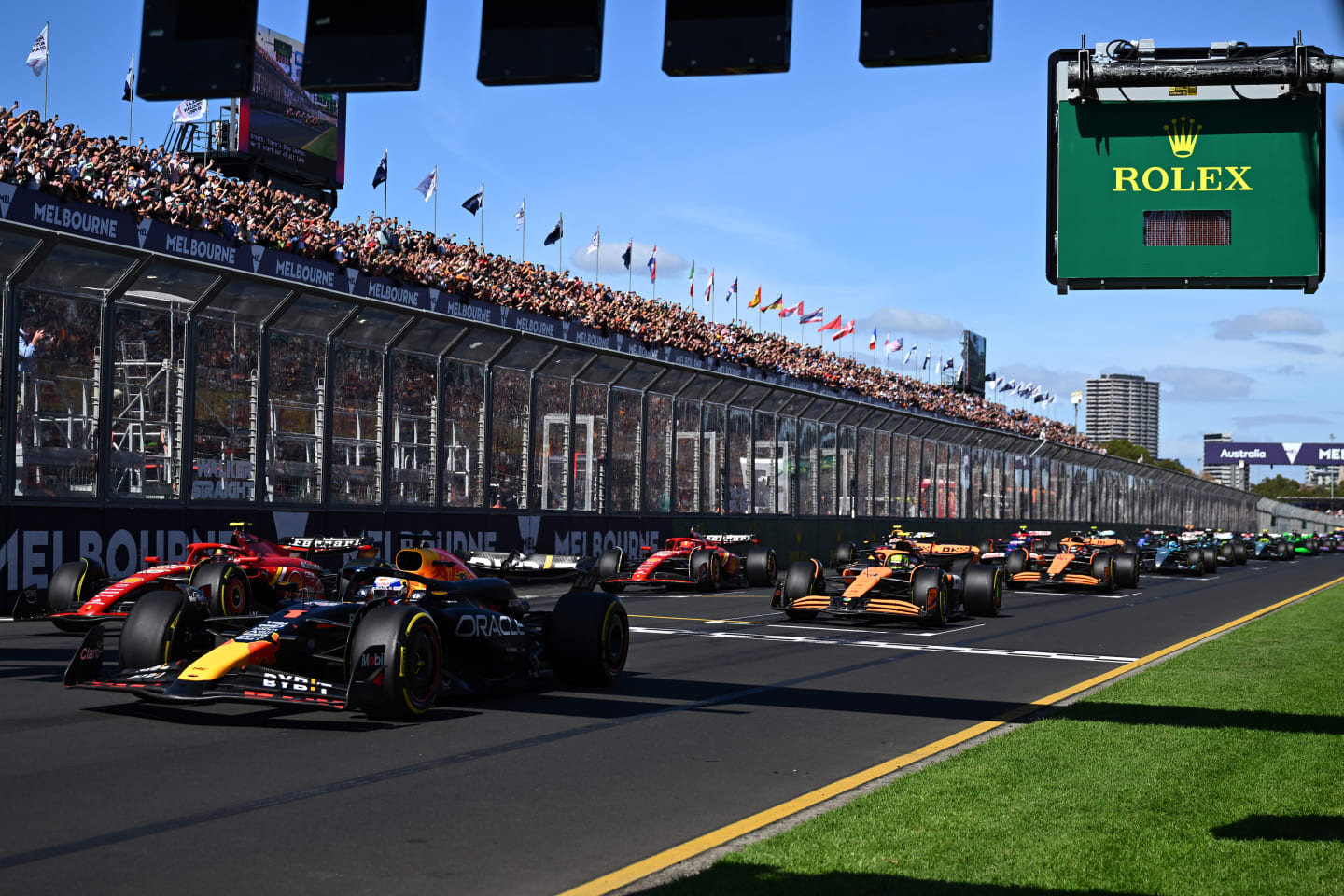 MELBOURNE, AUSTRALIA - MARCH 24: Max Verstappen of the Netherlands driving the (1) Oracle Red Bull Racing RB20 leads Carlos Sainz of Spain driving (55) the Ferrari SF-24 and the rest of the field at the start of the race during the F1 Grand Prix of Australia at Albert Park Circuit on March 24, 2024 in Melbourne, Australia. (Photo by Quinn Rooney - Formula 1/Formula 1 via Getty Images)